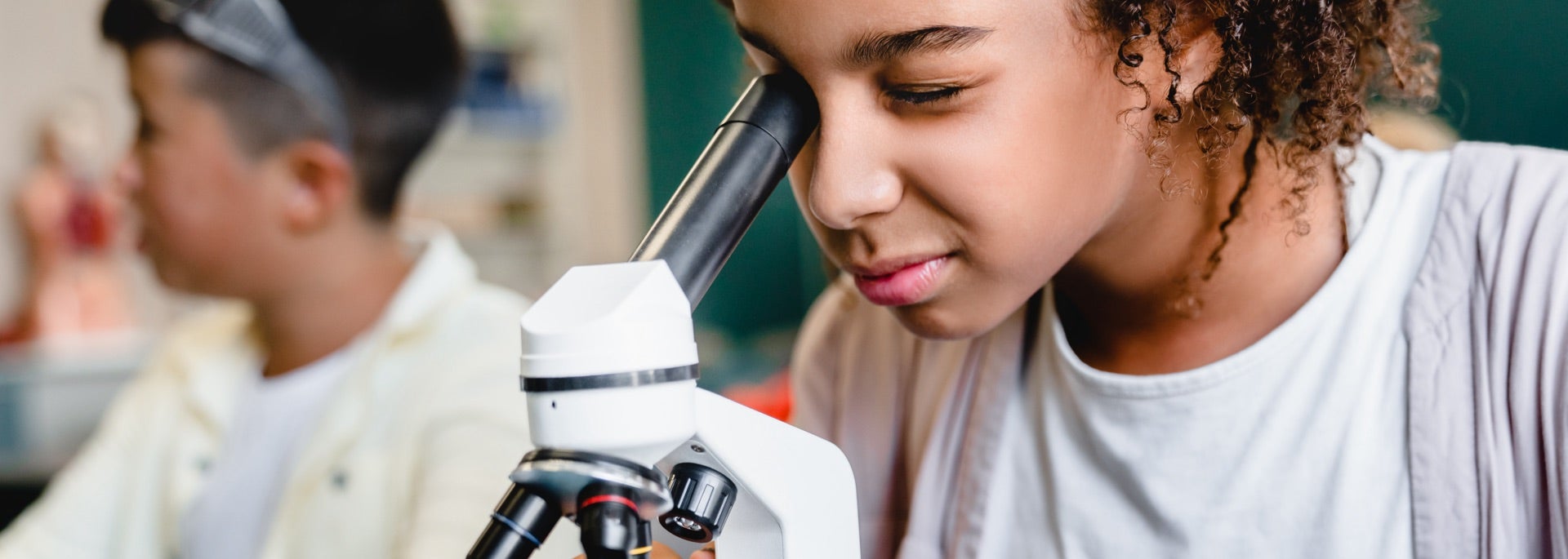 A student looking in a microscope, very scientifically